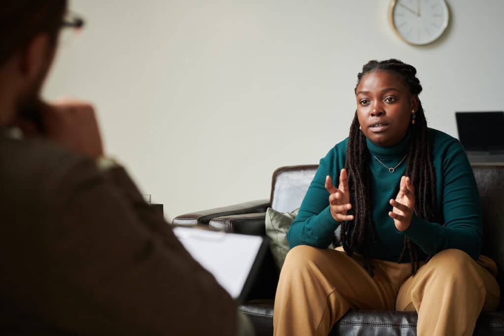 African American girl talking to psychologist at office